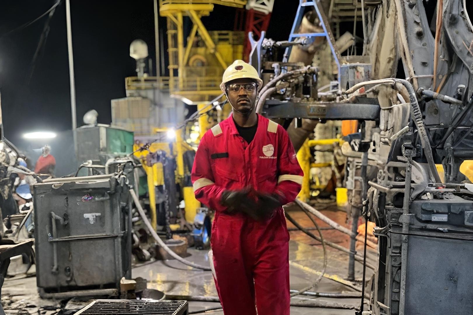 engineer in front of an oil rig